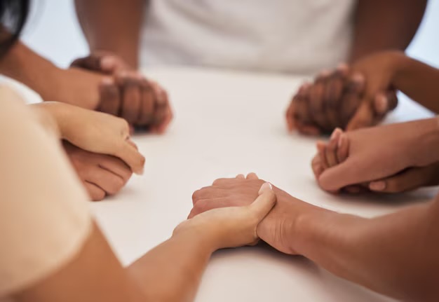 Women praying with hands clasped